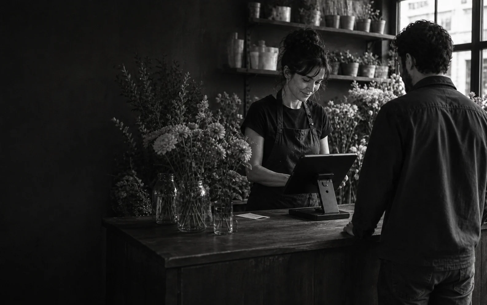An independent shop owner helping a customer